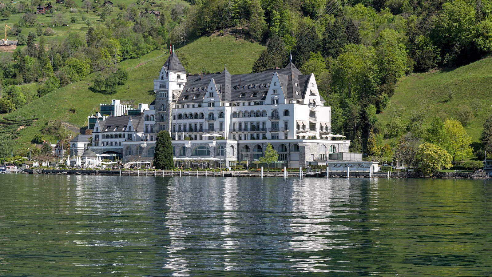 Grand resort exterior beside a tranquil lake